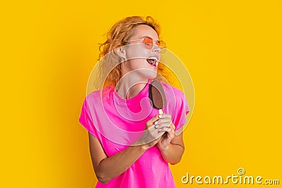 funny woman with icelolly ice cream isolated on yellow. woman with icelolly ice cream Stock Photo