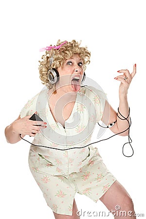 Funny woman in nightgown listening to music Stock Photo