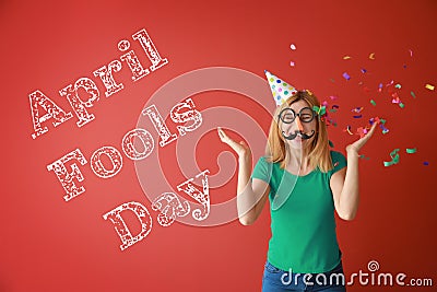 Funny woman with party decor and confetti for April Fools\' Day on color background Stock Photo