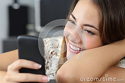 Funny woman using a smart phone at home Stock Photo