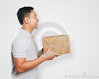 Funny Young Asian Courier Guy Giving Package Box Stock Photo