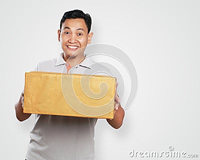 Funny Young Asian Courier Guy Giving Package Box Stock Photo