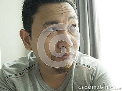 Funny Young Man Thinking Expression, Looking to The Side Stock Photo