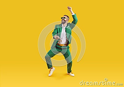 Funny young guy in green suit dancing and having fun at Saint Patrick's Day party Stock Photo