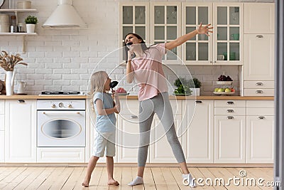 Funny young mom play sing with little daughter Stock Photo