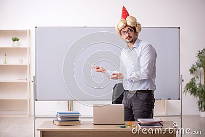 Funny young male teacher magician in the classroom Stock Photo