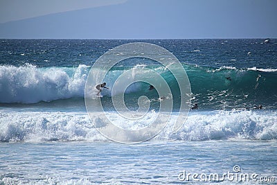 Funsport surfing in the turquoise waves at Playa de las America Tenerife, Spain Stock Photo