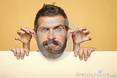 Funy face. Hipster with surprised face hold paper with female hand gesture. Stock Photo
