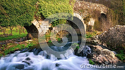 Furelos, Spain - The Medieval Bridge Puente San Xoan across the River Furelos, outside Melide in Galicia, on the Way of St James Stock Photo