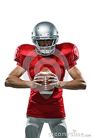 Furious American football player in red jersey and helmet holding ball Stock Photo