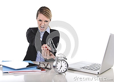 Furious angry businesswoman working pointing gun to alarm clock in out of time concept Stock Photo