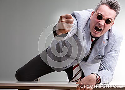 Furious belligerent man punching the camera Stock Photo