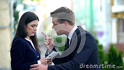 Furious boss scolding female employee for bad result of work, harassment Stock Photo