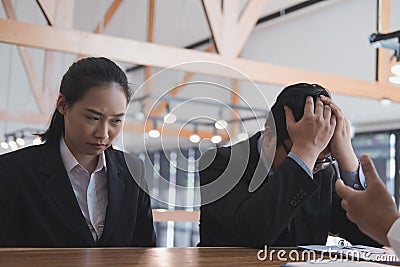 Furious boss scolding frustrated woman at office. irritated man Stock Photo