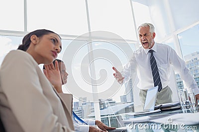 Furious boss yelling at colleagues Stock Photo