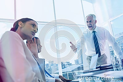 Furious boss yelling at colleagues Stock Photo