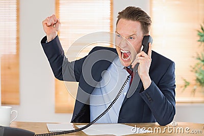 Furious businessman outraged on the phone Stock Photo