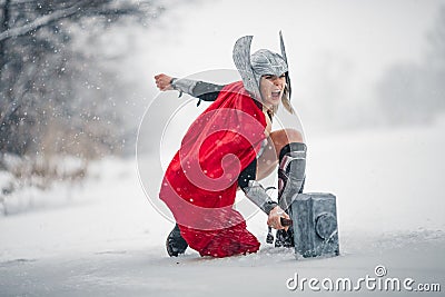 Furious woman in image of Germanic-Scandinavian God of thunder and storm. Cosplay. Stock Photo