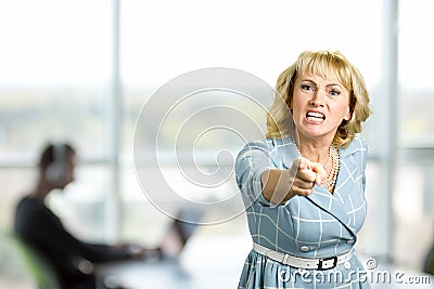 Furious woman, office window background. Stock Photo