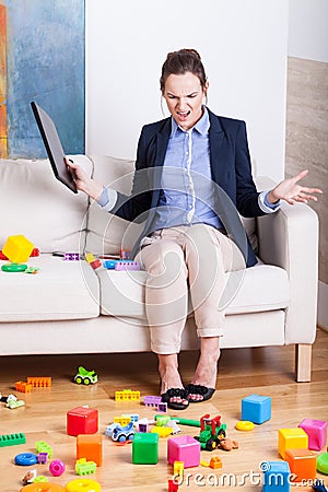 Furious woman in a room full of kids toys Stock Photo