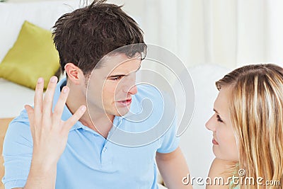 Furious young man working up against girlfriend Stock Photo