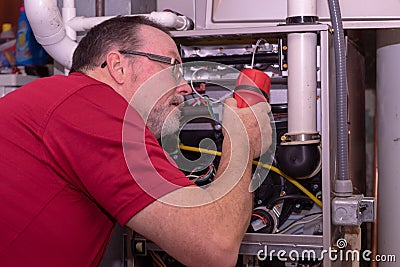 Furnace Tech Spotting A Issues In A Gas Furnace Stock Photo