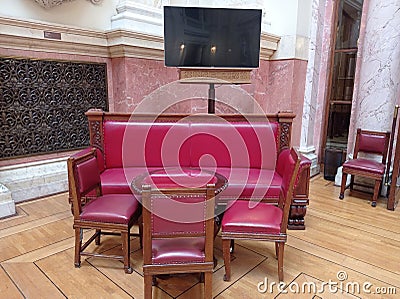 Furniture in the central hall of the Nacional Assembly of Serbia, elegant wooden red chairs, sofa and a brown - red table Editorial Stock Photo