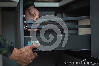 Assembling new modern drawer system with adjustment mechanism Stock Photo