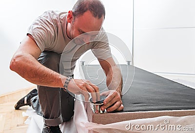 Furniture maker sets bed Stock Photo