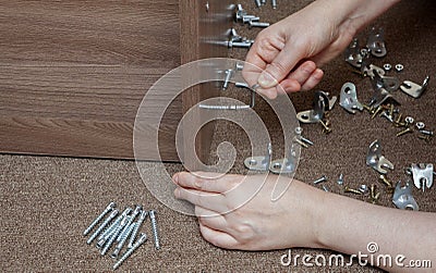 Furniture wooden assembly frame manually tightening using Stock Photo