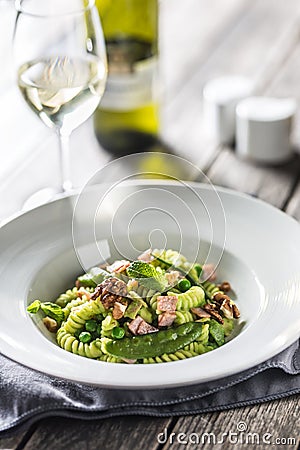 Fusilli pasta with green peas ham walnuts with white wine. italian or mediterranean cuisine Stock Photo