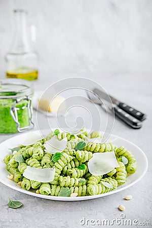 Fusilli pesto pasta with pine nuts, basil leaves and parmesan cheese Stock Photo