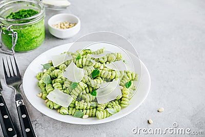 Fusilli pesto pasta with pine nuts, basil leaves and parmesan cheese Stock Photo
