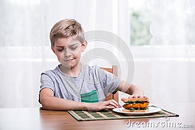 Fussy kid with chicken sandwich Stock Photo