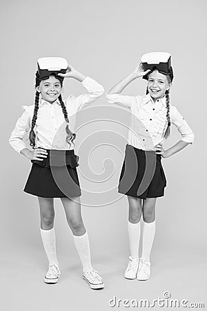 Future education. Digital education. School education. Children schoolgirls excited wear wireless VR glasses. Exploring Stock Photo