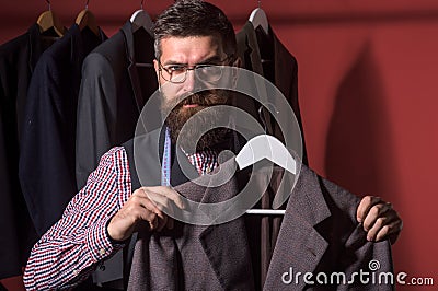 The future of fashion. suit store and fashion showroom. Bearded man tailor sewing jacket. sewing mechanization. retro Stock Photo