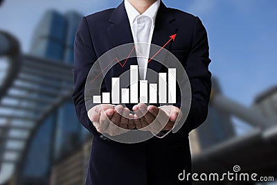 Future of financial business concept,Businessman with finance symbols coming and city backgrounds. Stock Photo