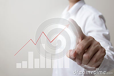 Future of financial business concept,Businessman touching increasing graph with finance symbols. Stock Photo