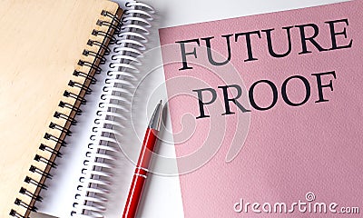 FUTURE PROOF word on the pink paper with office tools on white background Stock Photo