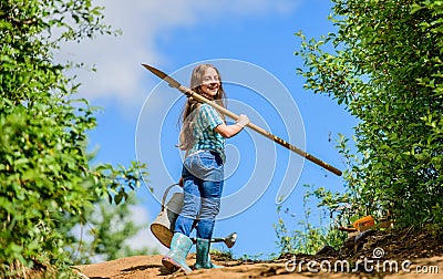 Future success. small girl on rancho. summer farming. farmer small girl. garden tools, shovel and watering can. kid Stock Photo