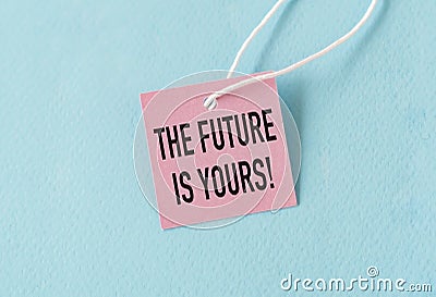 The Future Is Yours Text on Pink Paper Card on Blue Background Stock Photo