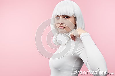 Futuristic female with earphones looking at camera Stock Photo