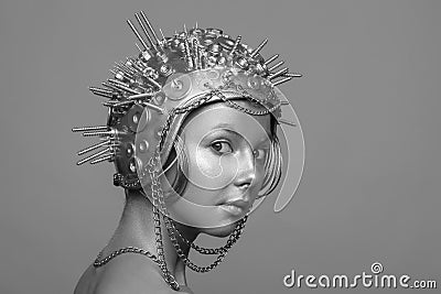 Futuristic woman in metal helmet with screws, nuts and chains Stock Photo