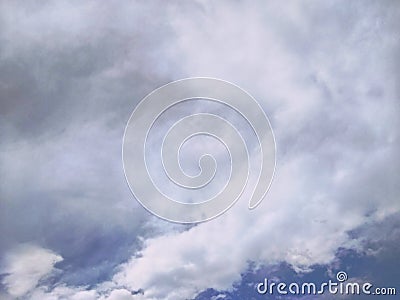 Fuzzy grey clouds on the blue sky Stock Photo