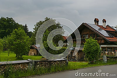 FÃ¼ssen, Germany 27 May 2019 - Cozy alpine houses with wooden roofs lost in green rainy valley among mountains. Little german Editorial Stock Photo