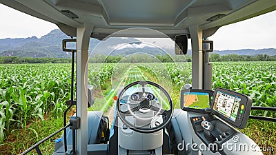 5G autonomous tractor working in corn field, Future technology with smart agriculture farming concept Stock Photo