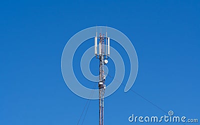 Technology on the top of the telecommunication GSM 4G tower antenna, transmitter, blue sky Stock Photo