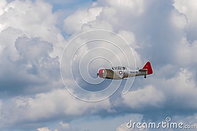 AT-6G Texan Flies By Clouds Editorial Stock Photo