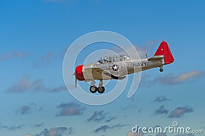 AT-6G Texan Flies By Ragged Clouds Editorial Stock Photo