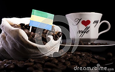 Gabon flag in a bag with coffee beans isolated on black Stock Photo